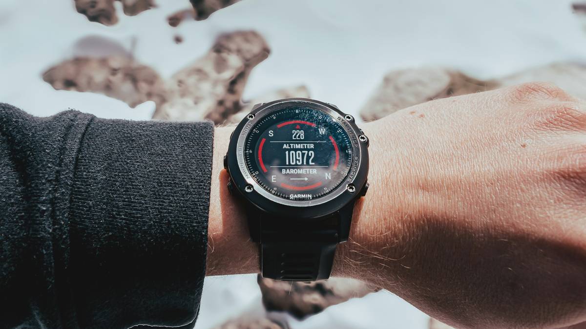 Close-up of wristwatch altimeter display showing real-time elevation changes during altitude awareness hiking tips demonstration